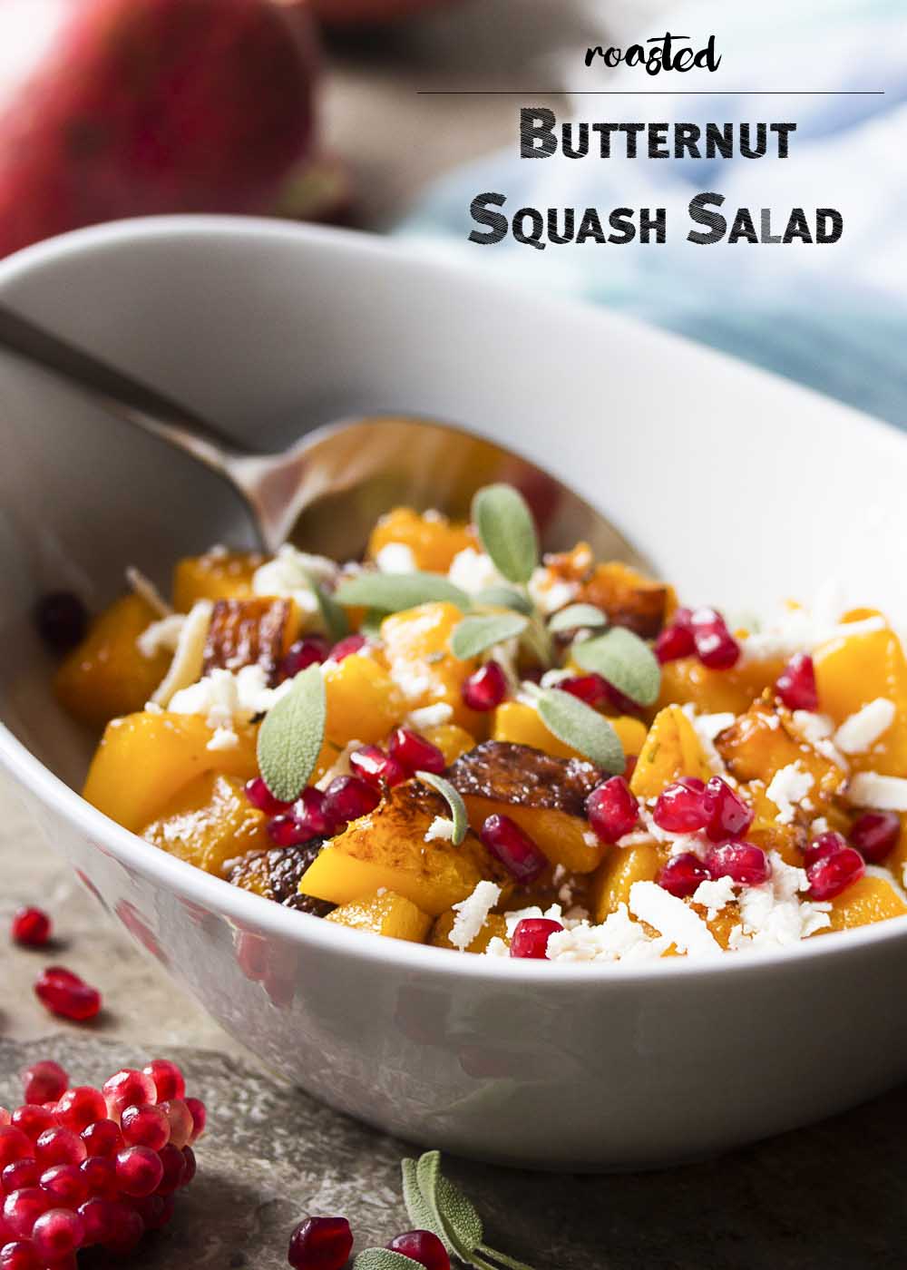 Winter squash, ricotta salata, and pomegranate seeds combine to make a warm roasted butternut squash salad which is perfect for fall. Great for the Thanksgiving and holiday table! Healthy. Gluten-Free. | justalittlebitofbacon.com