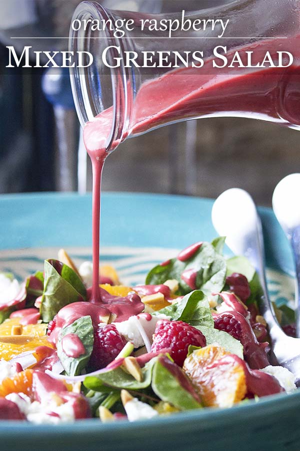 This sweet and tangy summer raspberry salad with mixed greens, oranges, goat cheese, and almonds is an easy and delicious side. Perfect with grilled meats. | justalittlebitofbacon.com #summerrecipes #glutenfree #saladrecipes #raspberries #healthyrecipes #salad