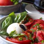 Healthy, simple, and fresh! This summer recipe for tomato burrata salad is drizzled with balsamic and topped with basil for an impressive and easy side. | justalittlebitofbacon.com #summerrecipes #burrata #italianrecipes #tomatosalad #saladrecipes #tomatoes