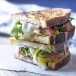 This spicy Italian panini is everything you love about Italian sub sandwiches in a toasted, melty, panini! Spicy peppers, gooey cheese, and yummy deli meats. Great for lunch or an easy dinner. | justalittlebitofbacon.com #panini #italianrecipes #sandwiches #italian