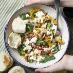 Roasted delicata squash salad is tossed with baby kale, roasted chickpeas, crumbled feta, and pomegranate and then drizzled with a creamy tahini dressing for a hearty and cozy fall vegetarian meal. Skip the feta for a vegan salad. Great as a side for Thanksgiving too! | justalittlebitofbacon.com #fallsalad #saladrecipe #vegetarianrecipe #delicatasquash #thanksgiving