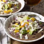 Healthy and easy vegetarian black bean soup is a quick stove top dinner! Creamy without cream and full of flavor, its a perfect weeknight dinner. And even better with ALL the toppings - avocado, jalapenos, sour cream, diced onion, and more. | justalittlebitofbacon.com #blackbeansoup #beansoup #vegetarian #mexicanfood #easydinners