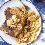 Pull out your cast iron skillet to make these amazing breaded cheese stuffed pork chops for two! Start these Italian style bone-in chops on the stove top then move to the oven and finish up by making a quick sauce to serve over pasta. | justalittlebitofbacon.com #porkchops #porkrecipes #italianrecipes #datenightrecipes #dinnerfortwo