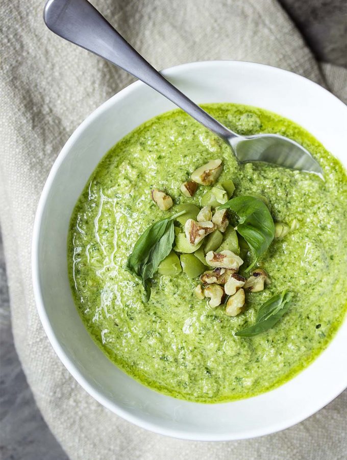 This quick puree of olives, basil, parsley, and walnuts with olive oil makes a delicious and versatile homemade green olive pesto. Amazing over pasta, on crostini, as a dip, in a sandwich, and more! | justalittlebitofbacon.com #italianrecipes #meditrraneandiet #italian #pesto #greenolives #italianfood