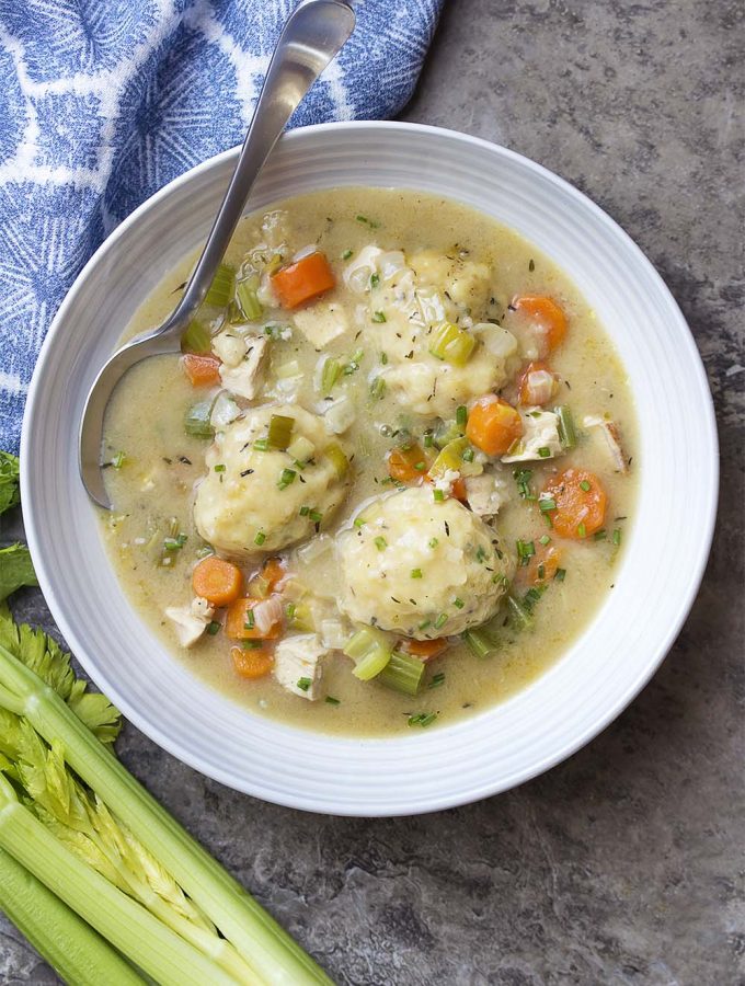 Creamy comfort food from scratch! You'll love this classic recipe for old-fashioned homemade chicken and dumplings cooked on the stovetop. | justalittlebitofbacon.com #comfortfood #chickendinner #winterrecipes #chickenanddumplings #chickenstew