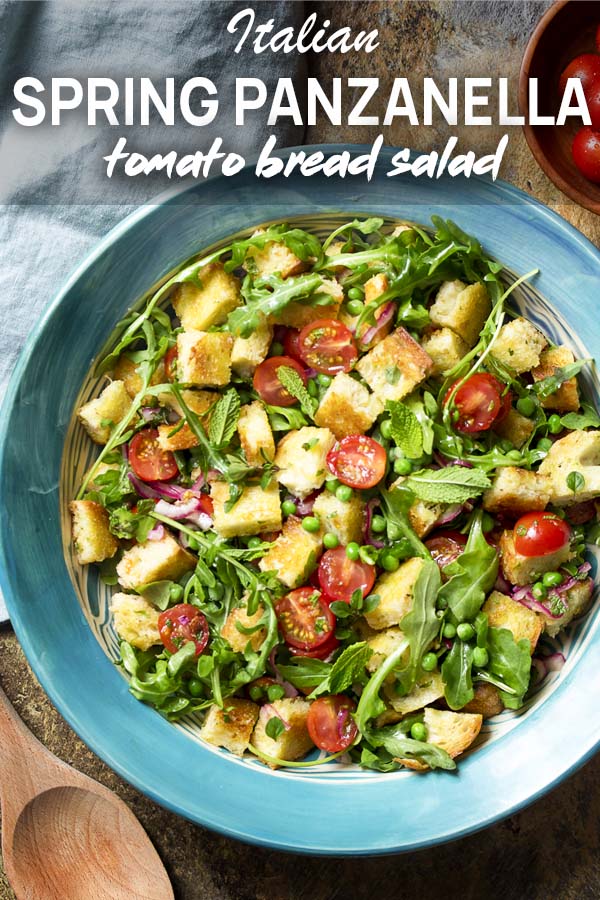 Bread salad in a serving bowl with text overlay - Italian Spring Panzanella