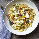 Looking for some healthy weeknight comfort food? In this recipe for vegetarian Mediterranean pasta, toss spaghetti with sliced red peppers, feta, artichokes, and kalamata olives for an easy dinner full of great flavors and tasty veggies! | justalittlebitofbacon.com #mediterraneandiet #mediterraneanrecipes #greekrecipes #pastarecipes #vegetarian #vegetarianpasta