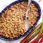 Looking for an easy fruit dessert recipe? This spiced rhubarb crisp is a simple, old fashioned dessert full of the flavors of cinnamon, ginger, and cloves and topped with an oatmeal pecan crumble! Best served with a scoop of vanilla ice cream. | justalittlebitofbacon.com #rhubarb #dessertrecipes #spring #fruitcrisp #dessert #crisp