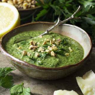 Italian walnut parsley pesto is a quick and easy recipe great all year round and perfect in the winter! Wonderful for dinner with salmon or chicken or tossed with pasta to make a creamy sauce. | justalittlebitofbacon.com #italianrecipes #sauces #pesto #parsley #walnuts