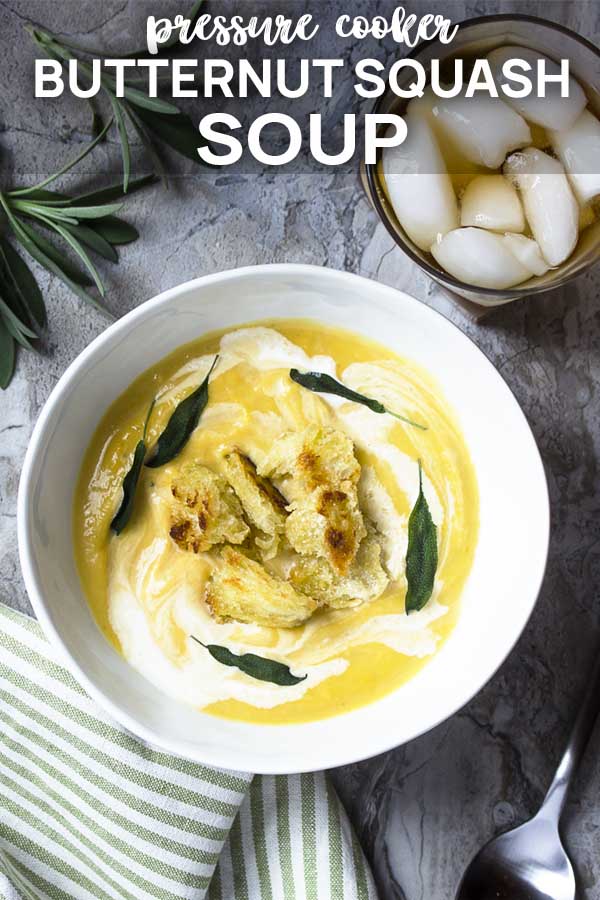 Soup in a white bowl topped by croutons and sage with text overlay - Butternut Squash Soup.