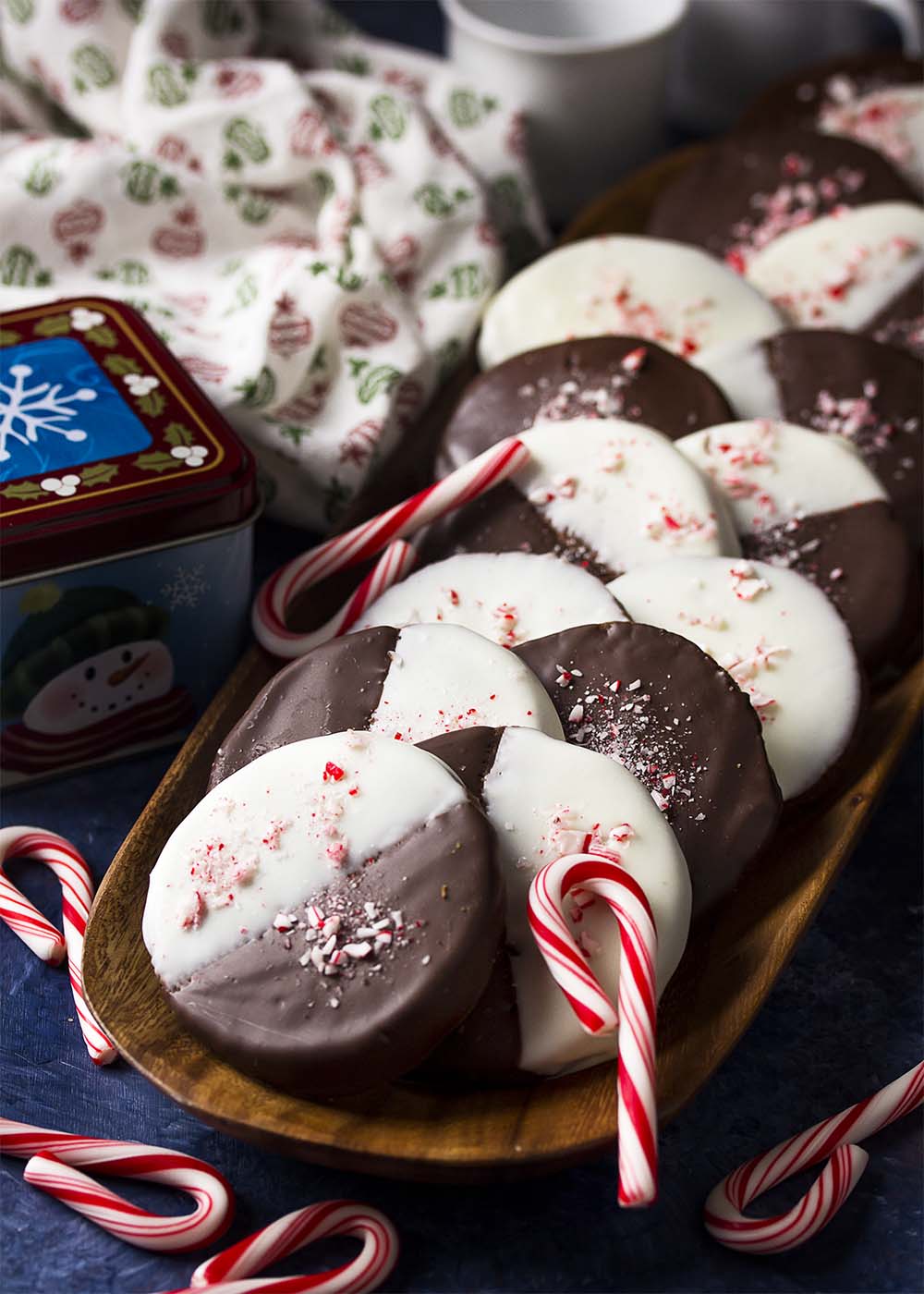 A tray of peppermint chocolate dipped cookies with white and dark chocolate.