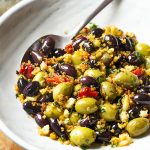 For a fun appetizer recipe, toss green and black olives with fresh spiced bread crumbs in this easy Spanish olive tapas! Perfect for dinner parties, holidays, and snacks. | justalittlebitofbacon.com #christmasrecipes #newyearsrecipes #holidayrecipes #tapasrecipes #spanishrecipes #tapas #olives