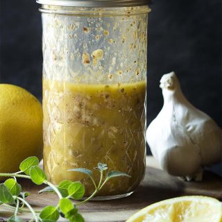 Here is the best homemade Greek salad dressing! This classic vinaigrette with lemon juice, red wine vinegar, olive oil and other pantry ingredients is easy to shake up in a mason jar. Perfect over traditional Greek salad. | justalittlebitofbacon.com #saladrecipes #salad #saladdressing #vinaigrette #greekrecipes #greek
