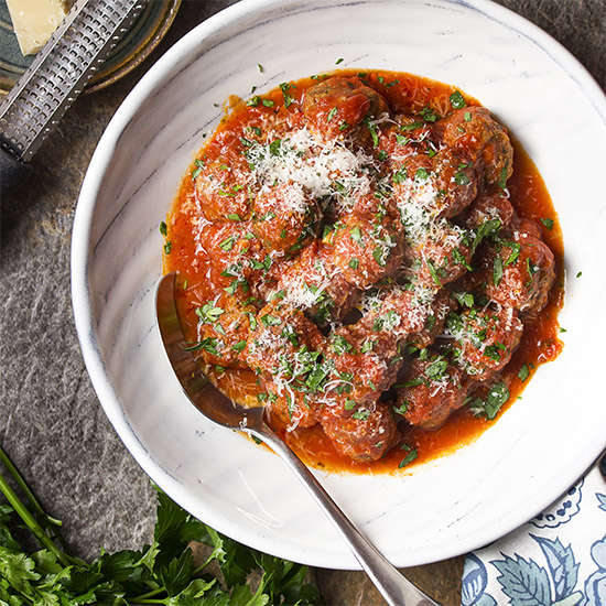 Learn how to make classic homemade meatballs! For the BEST authentic Italian meatballs and sauce mix together ground beef with fresh bread crumbs, parmesan, and spices then then pan fry and braise until tender. | justalittlebitofbacon.com #italianrecipes #italianfood #meatballs #beefrecipes #beef
