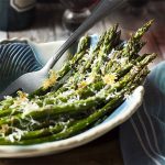 For an easy and quick side dish, cook my oven roasted asparagus with parmesan! This delicious Mediterranean recipe makes delicious use of spring produce with crispy cheese, tender veggies, and a sprinkle of balsamic. | justalittlebitofbacon.com #italianrecipes #italianfood #mediterraneanfood #springrecipes #asparagus #spring
