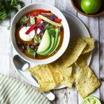 My spicy vegetarian tortilla soup is easy, healthy, AND quick! This is a pantry meal you can make in 30 minutes for a delicious and satifying dinner. Rich broth, smoky chipotles, plenty of black beans, and crunchy tortilla chips. | justalittlebitofbacon.com #mexicanfood #mexicanrecipes #souprecipes #pantryrecipes #soup #mexican #blackbeans #vegetariandinners