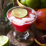 Try something a little different and learn how to make a blood orange margarita! Grab your tequila and mix up one or make a pitcher for a crowd. Either way you'll love this easy and delicious homemade cocktail. | justalittlebitofbacon.com #cocktails #drinkrecipes #margaritas #bloodoranges #pitcherdrinks