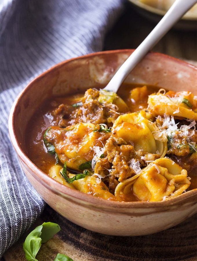 Get dinner on the table in 30 minutes with my Italian sausage tortellini soup! It's a snap to make this easy stovetop meal. Perfect for weeknights and family pleasing. | justalittlebitofbacon.com #italianrecipes #souprecipes #pastarecipes #italian #italianfood #tortellini #soup