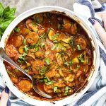 My Italian sausage and zucchini casserole is full of sauteed summer squash, sliced onions, and thick tomato sauce! Perfect for a summer dinner, a potluck, or a backyard bbq. | justalittlebitofbacon.com #summerrecipes #italianfood #zucchinirecipes #zucchini #summersquash #italiansausage