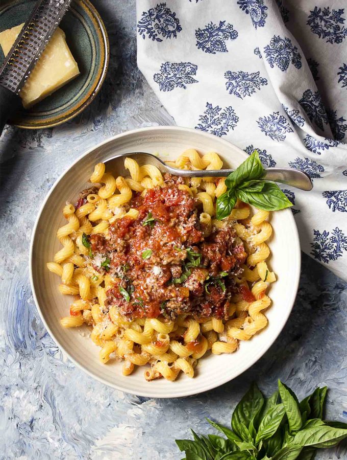 You'll love my easy and quick Italian meat sauce! This homemade recipe featuring canned tomatoes and ground beef is perfect over spaghetti, pasta, or zoodles and is a great weeknight dinner. | justalittlebitofbacon.com #tomatosauce #italianrecipes #meatsauce #italianfood