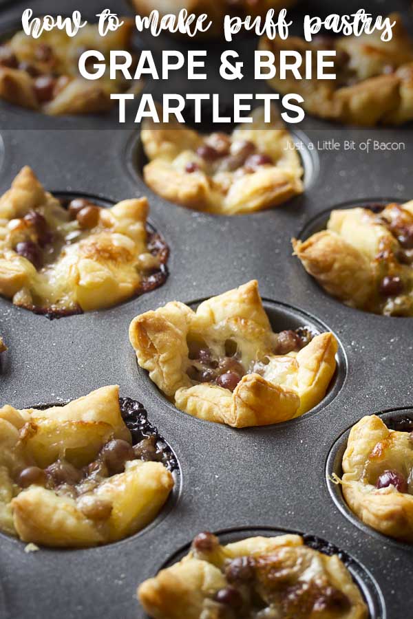 Puff pastry tarts in a baking pan with text overlay - Grape and Brie Tartlets.