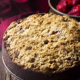Enjoy a slice of moist and delicious banana strawberry cake! This crumb topped coffee cake with fruit filling is perfect for breakfast, snacks, or dessert. | justalittlebitofbacon.com #cakerecipes #dessertrecipes #coffeecake #bananacake #strawberries #bananas