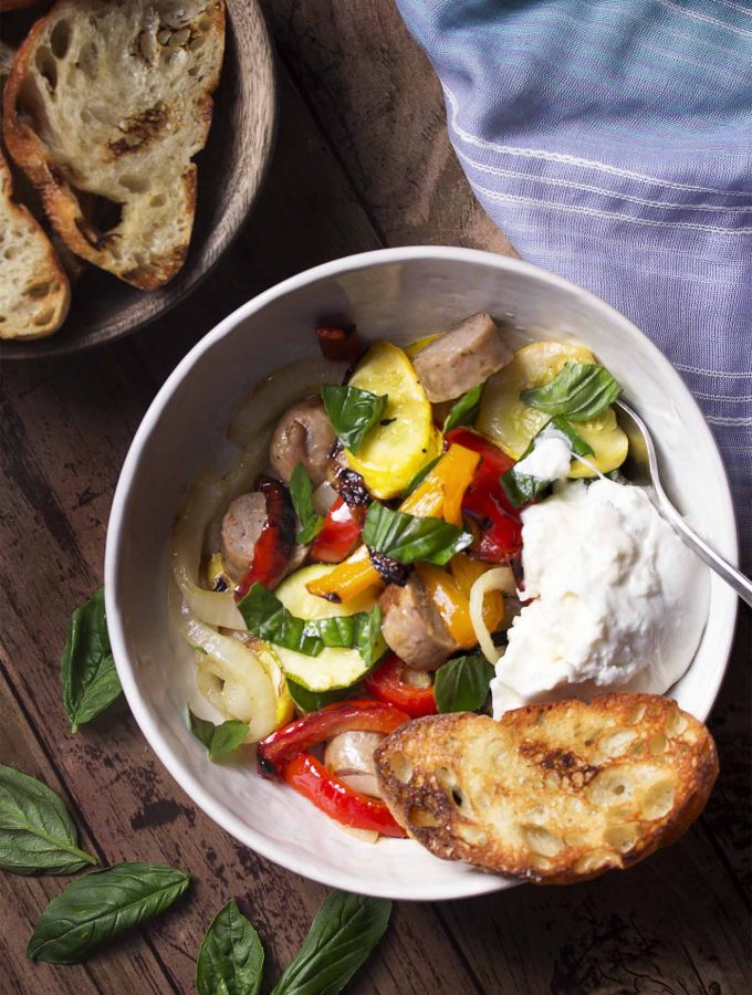 Heat up the grill to make a salad full of summer zucchini and peppers tossed with Italian sausage and drizzled with a bright lemon dressing. Complete this easy meal with some grilled bread and burrata. | justalittlebitofbacon.com
