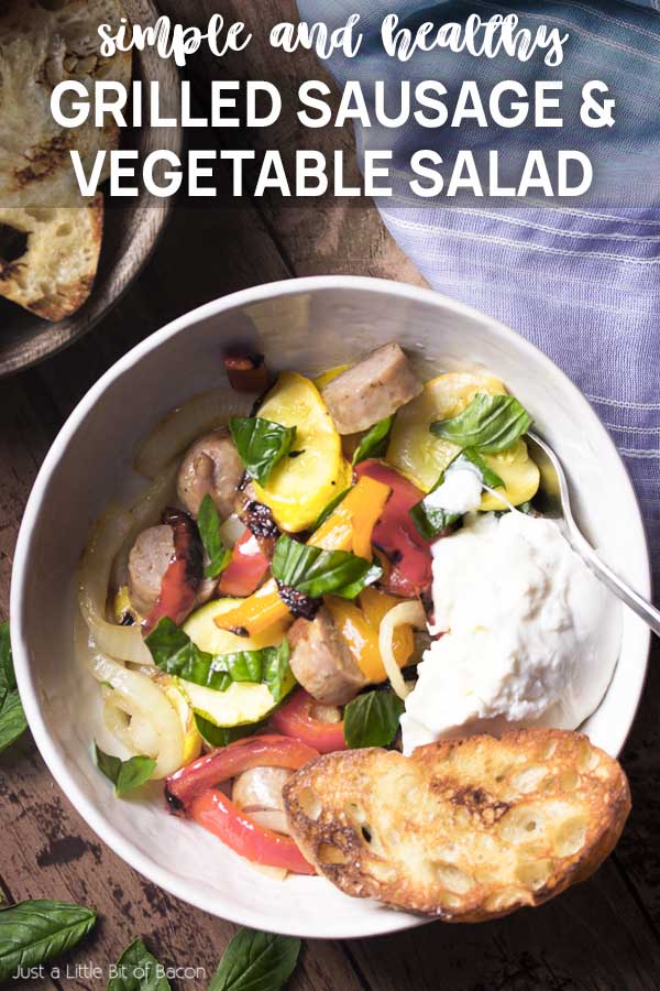Top view of a bowl of grilled meat and vegetables with text overlay - Grilled Sausage and Vegetable Salad.