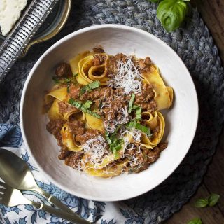 For the best homemade sauce, make my classic ragu bolognese! It's an authentic Italian recipe full of ground beef and pancetta with a little tomato all served over pappardelle pasta. | justalittlebitofbacon.com