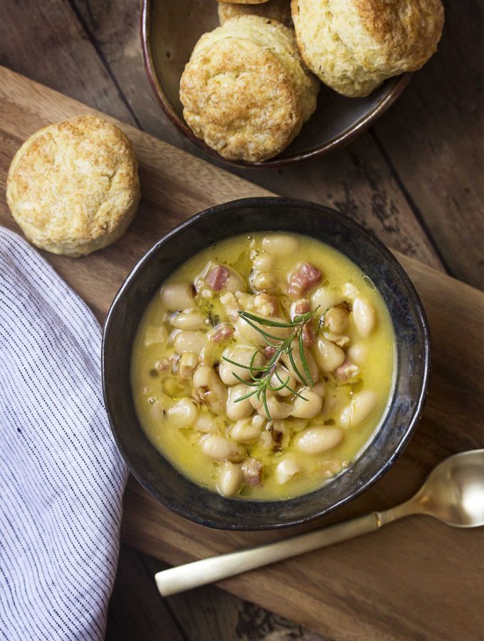 My creamy Tuscan white bean soup is flavored with pancetta and rosemary and uses canned cannellini beans for delicious and easy weeknight dinner. | justalittlebitofbacon.com
