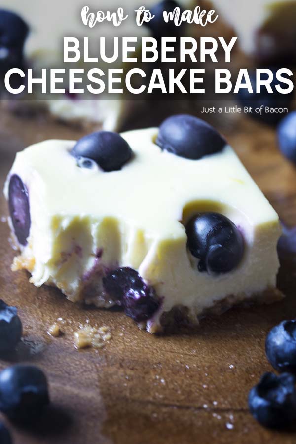 A cheesecake bar with a bite out of it and text overlay - Blueberry Cheesecake Bars.
